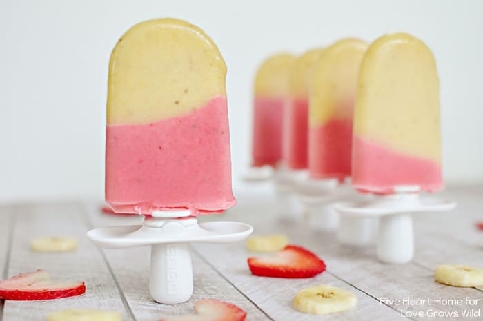 Cold and creamy Strawberry Banana Popsicles are the perfect summertime treat! | LoveGrowsWild.com