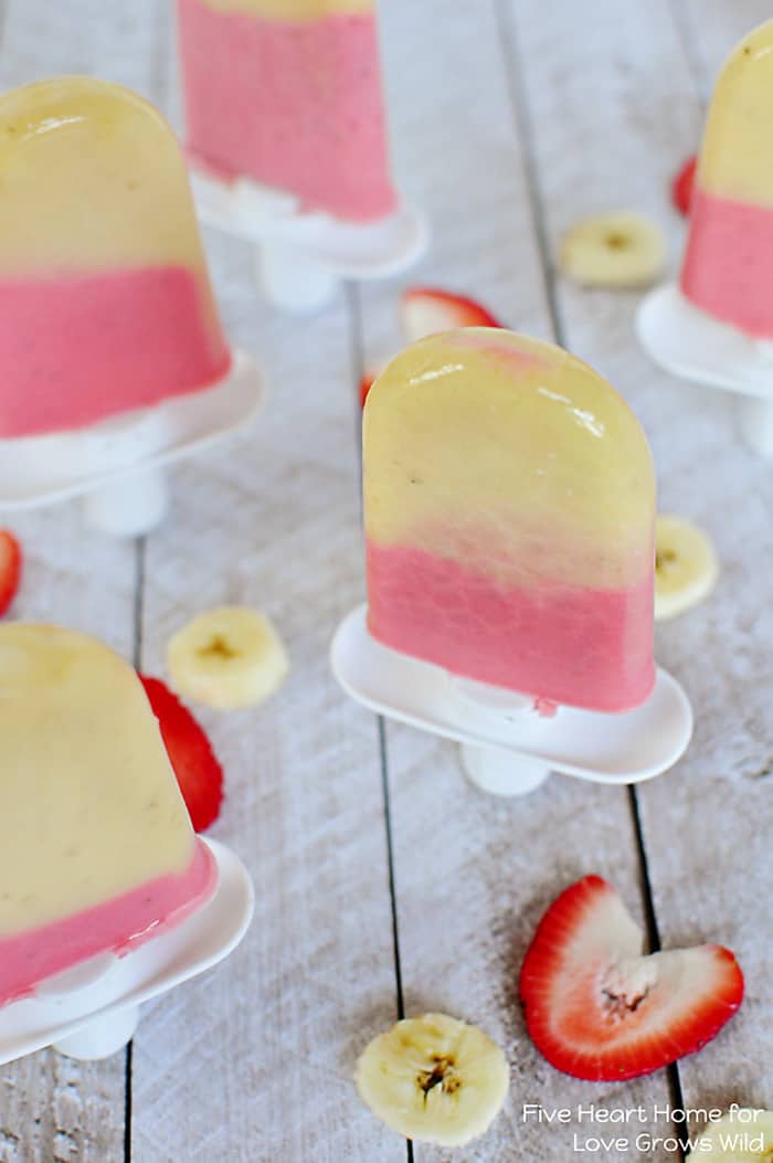 Cold and creamy Strawberry Banana Popsicles are the perfect summertime treat! | LoveGrowsWild.com