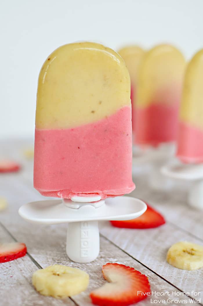Cold and creamy Strawberry Banana Popsicles are the perfect summertime treat! | LoveGrowsWild.com