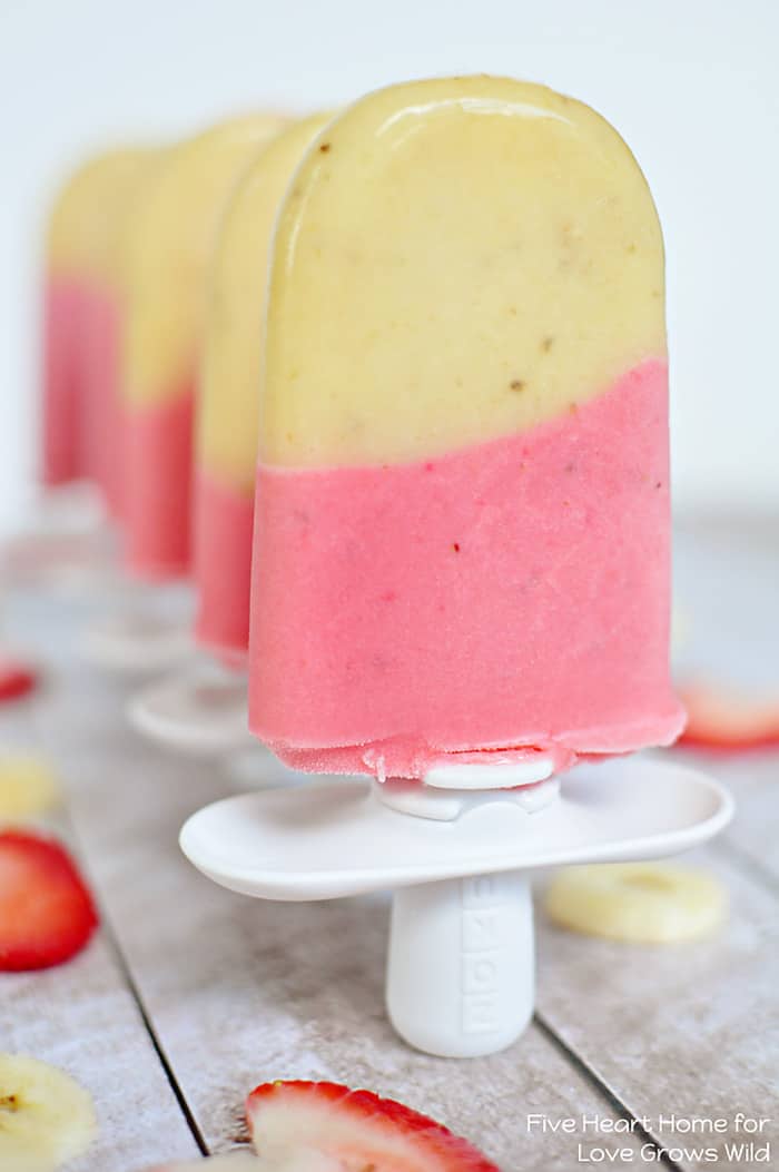 Cold and creamy Strawberry Banana Popsicles are the perfect summertime treat! | LoveGrowsWild.com