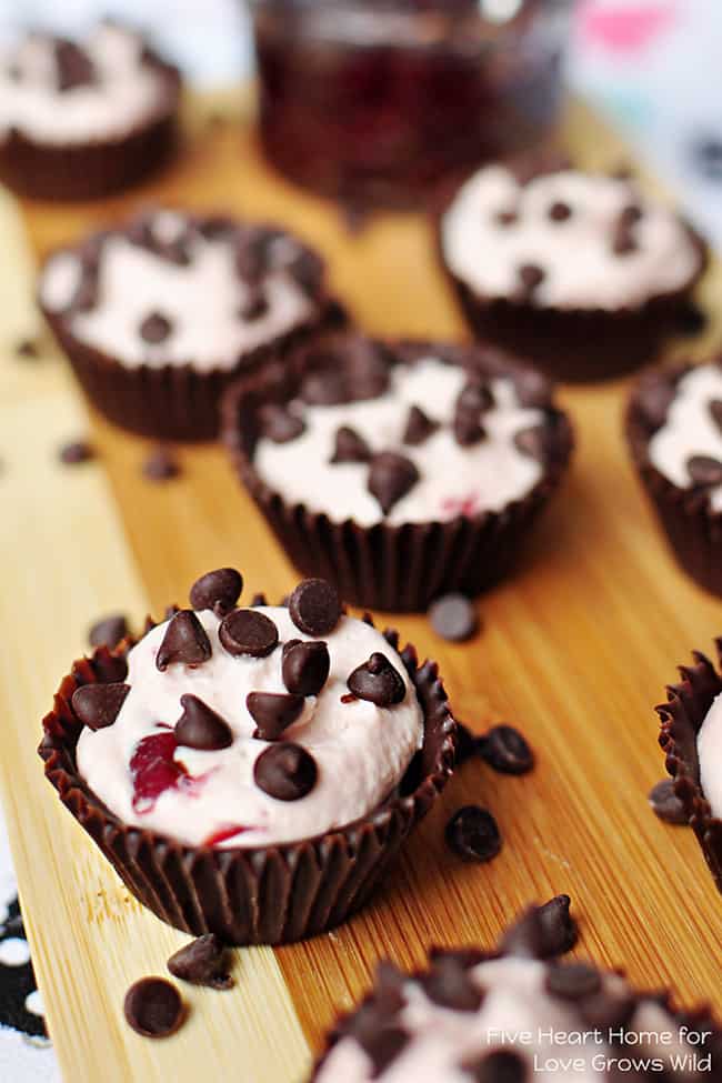 Cherry Cheesecake Chocolate Cups - A light and creamy, cherry-infused, no-bake cheesecake filling is piped into cute, edible chocolate cups for perfect bite-size treats!