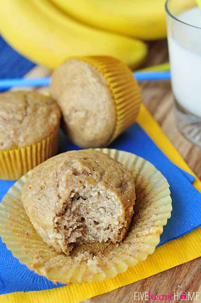 Whole Wheat and Honey Banana Muffins with liner peeled back and bite missing