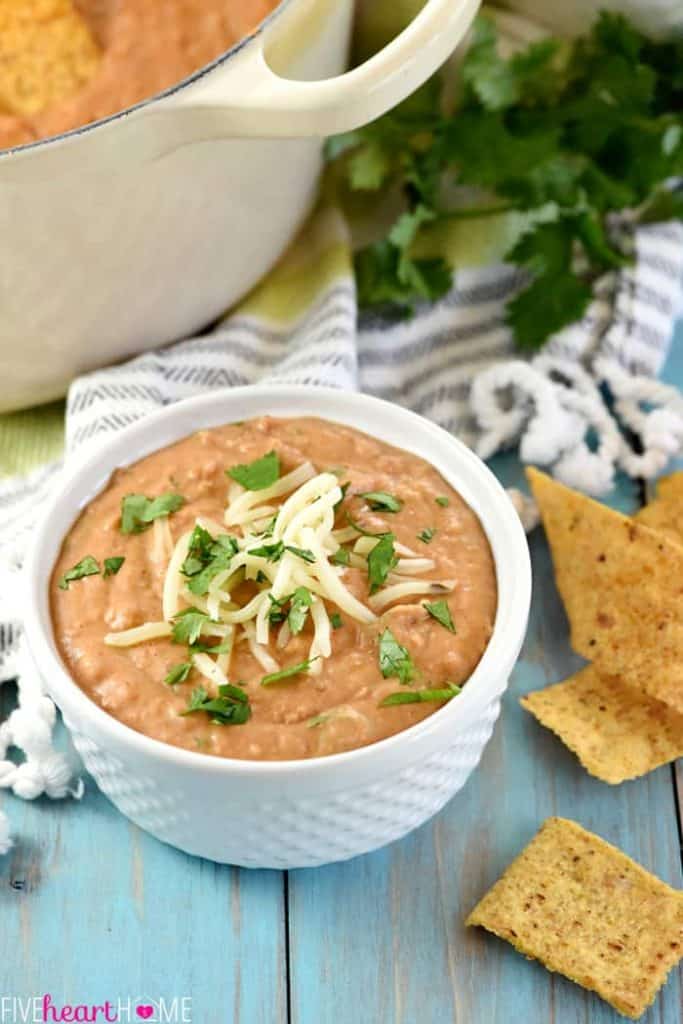 Ultimate Bean Dip ~ requiring a handful of simple ingredients -- refried beans, cream cheese, salsa, pepper jack, and cilantro -- and taking just 10 minutes to make, this stove-top appetizer recipe is creamy and cheesy...the perfect snack for parties or for watching the big game! | FiveHeartHome.com