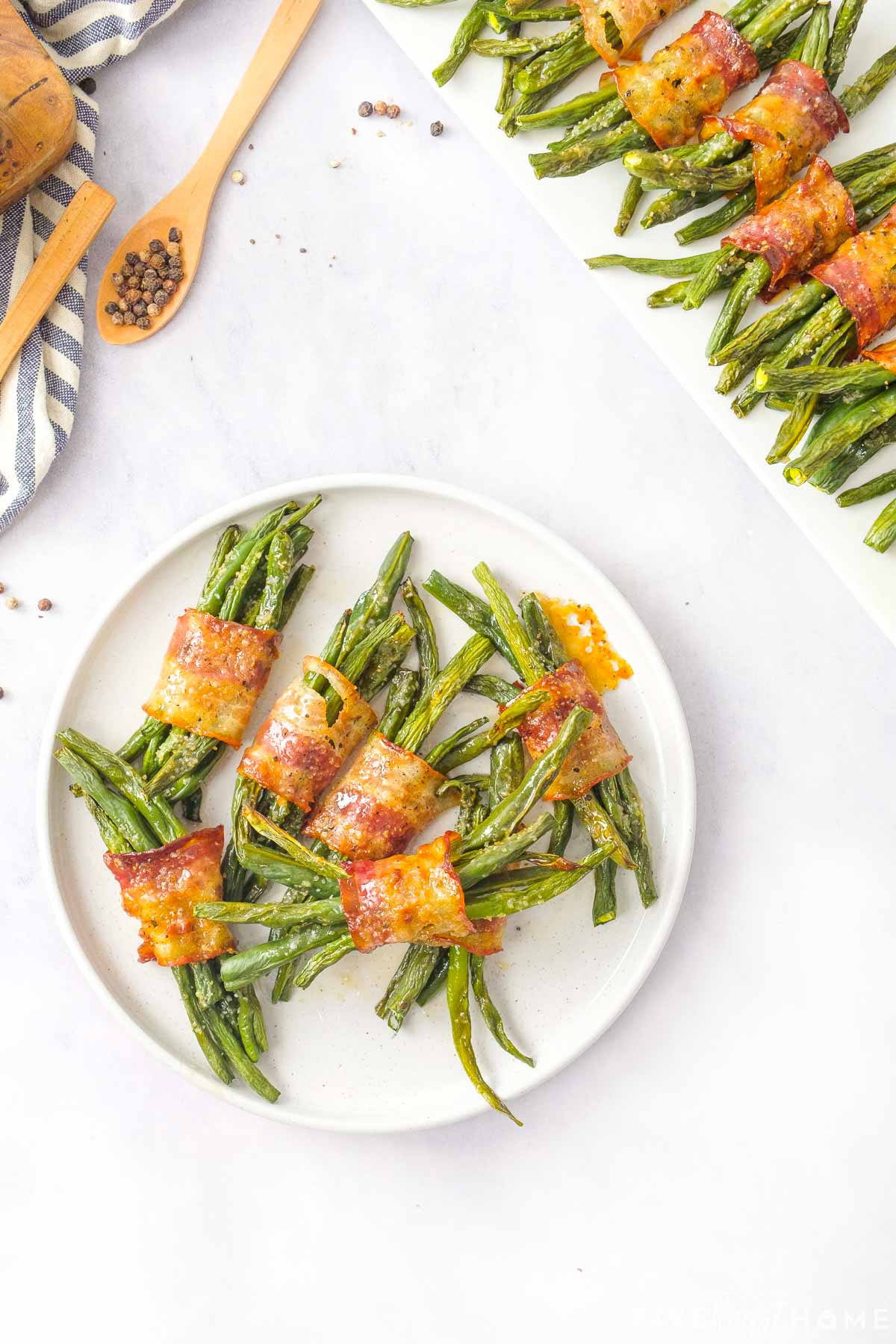 Aerial view of Green Bean Bundles on round white plate.