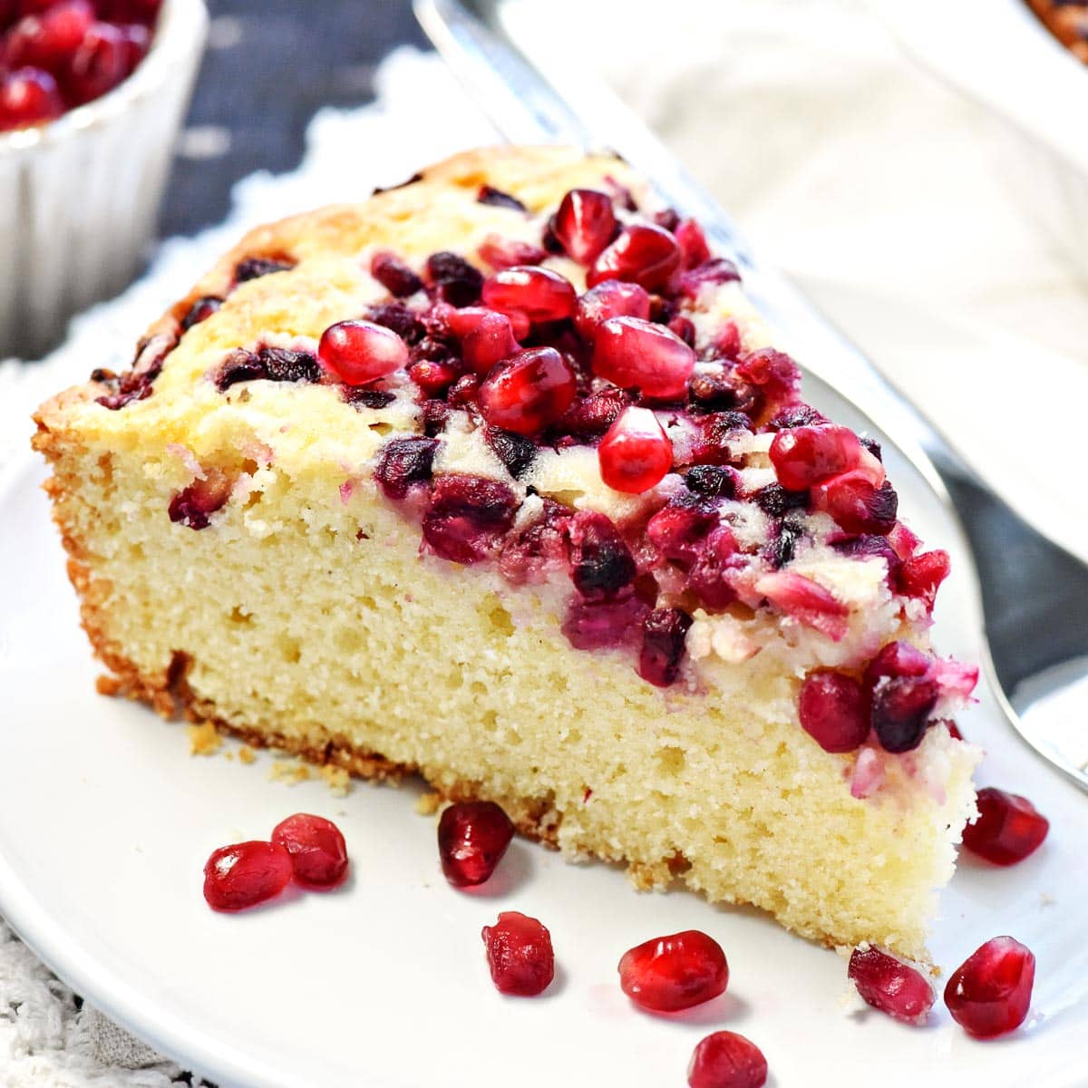 Pomegranate Cake with arils on plate.