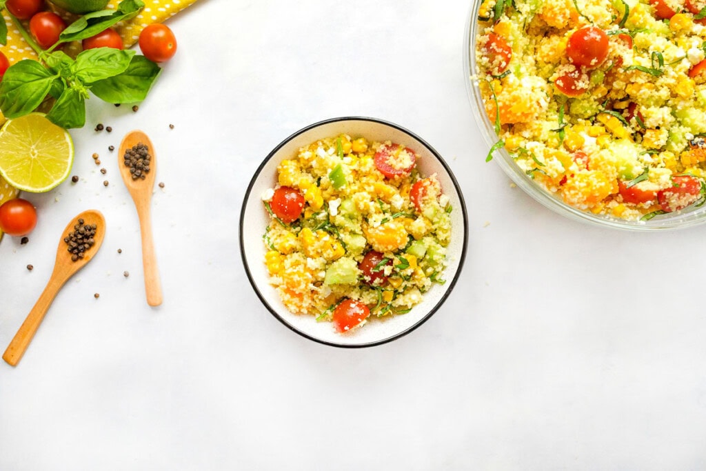Couscous Salad recipe in serving bowl and individual bowl.