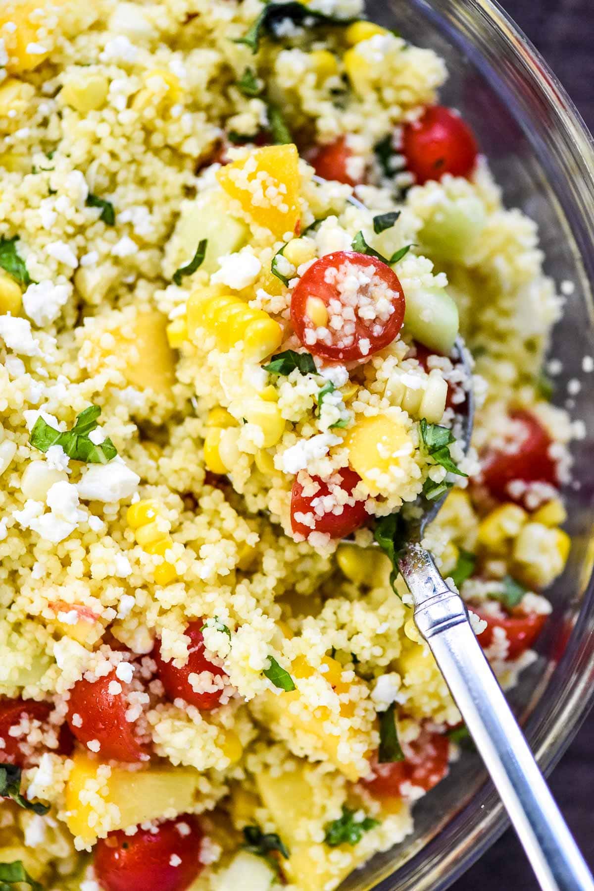 Couscous Salad being scooped up by spoon.