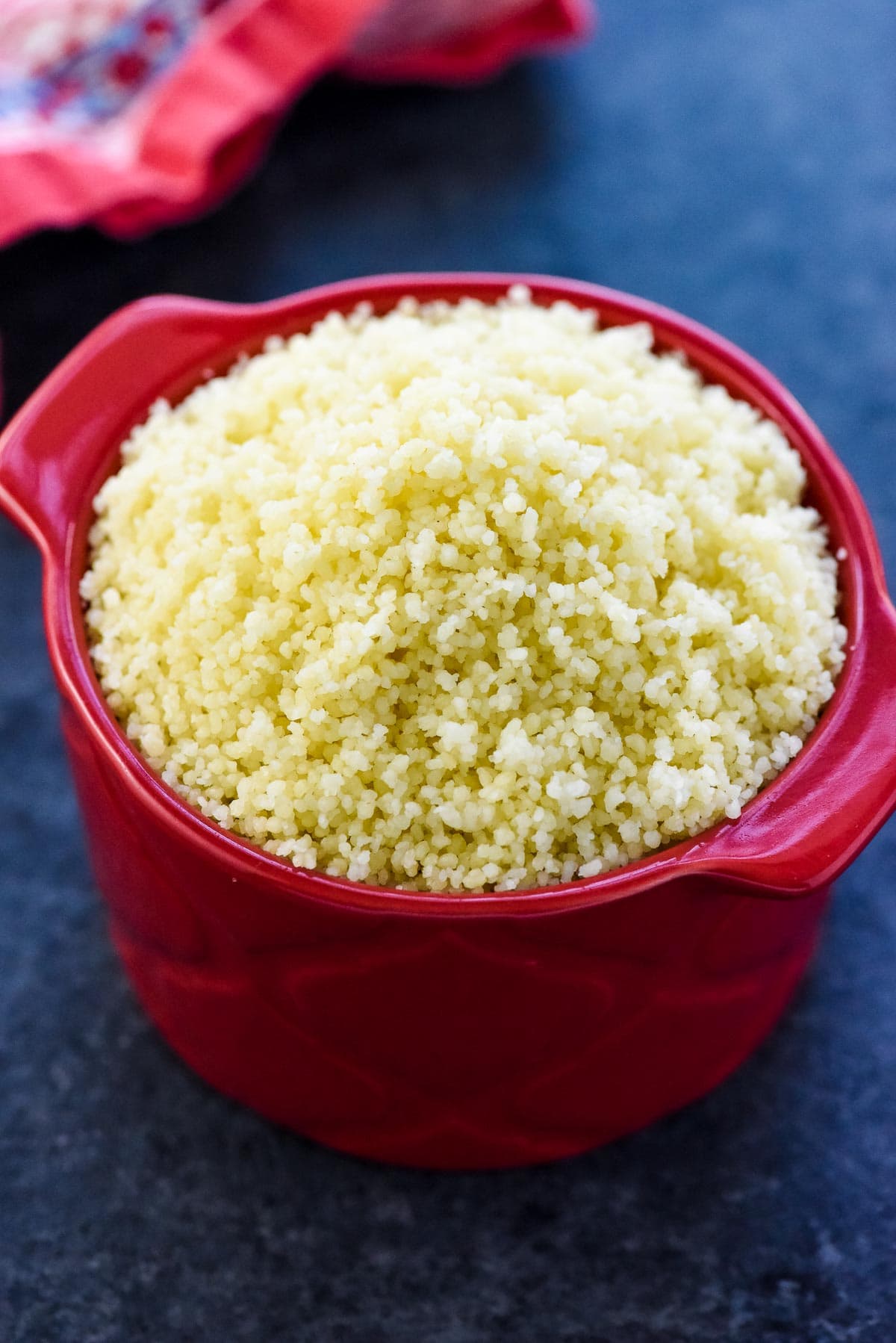 Couscous in a small red bowl.