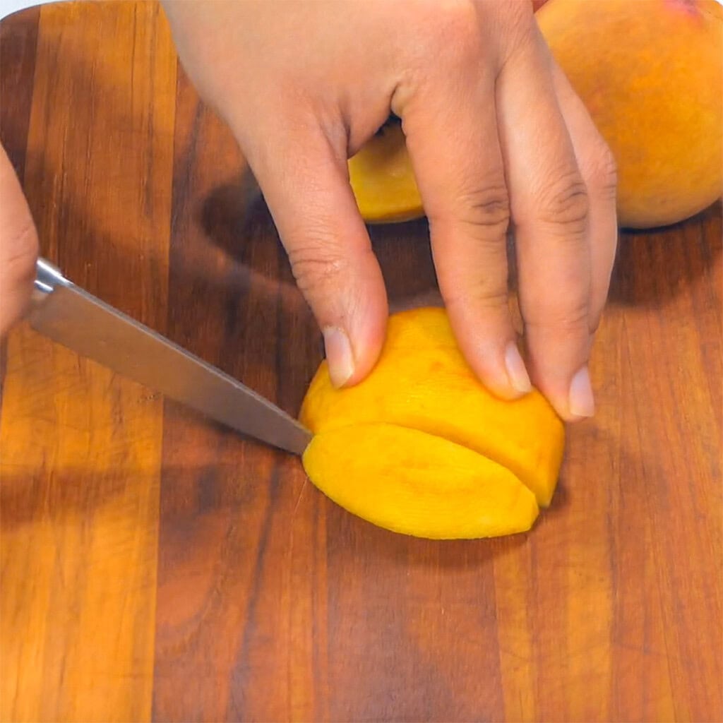 Slicing a fresh peach.