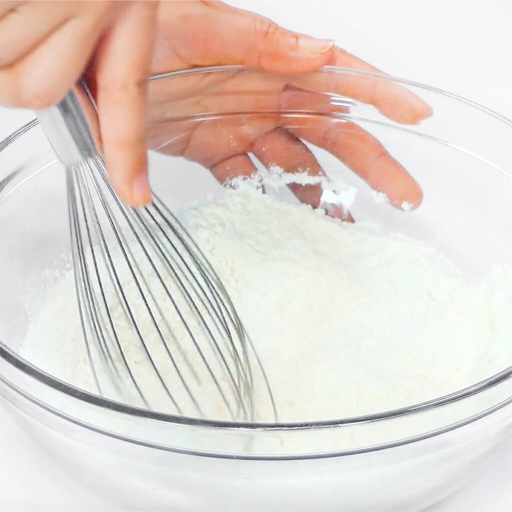 Whisking dry ingredients together.