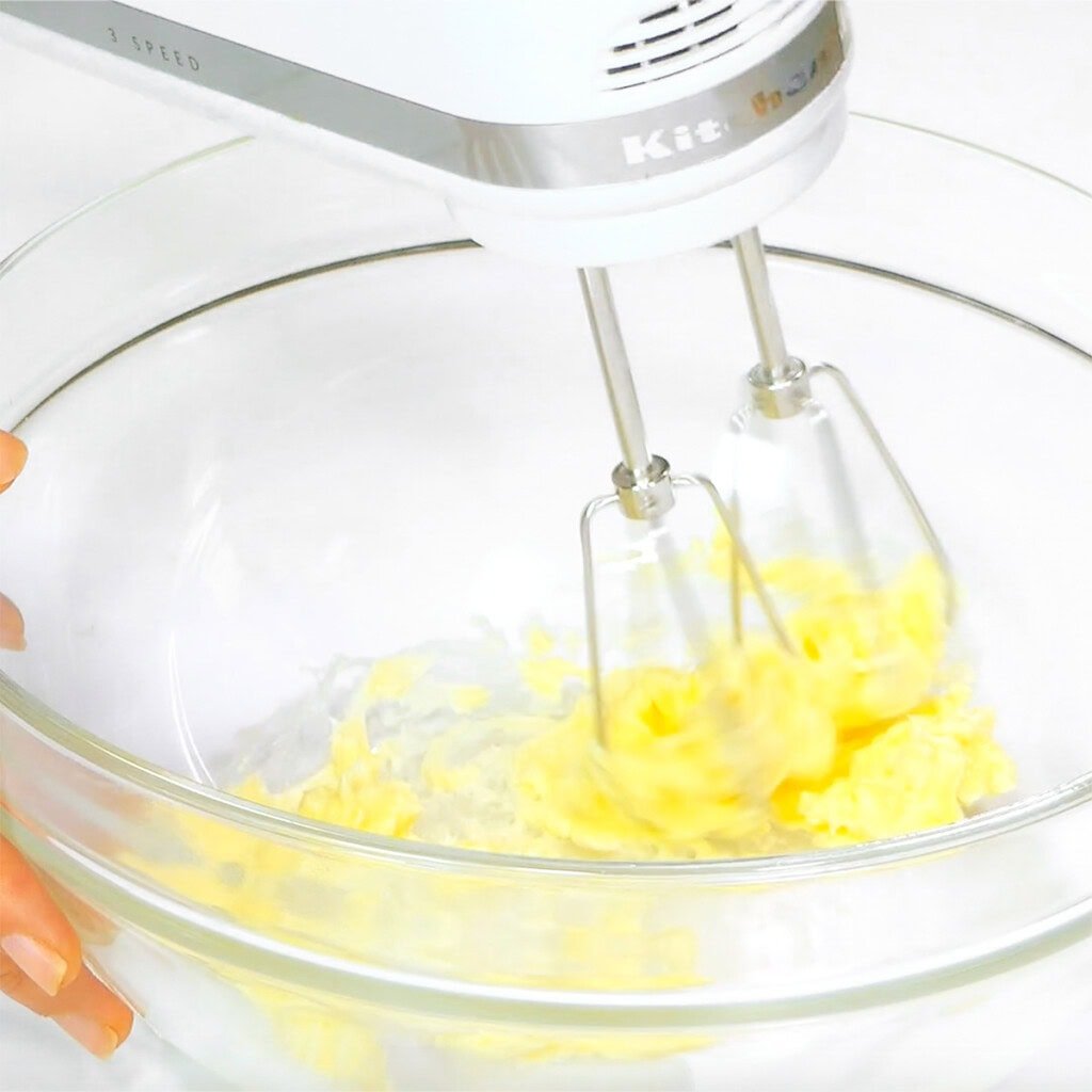 Beating butter with electric mixer.