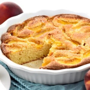 Peach Cake in dish with missing piece.