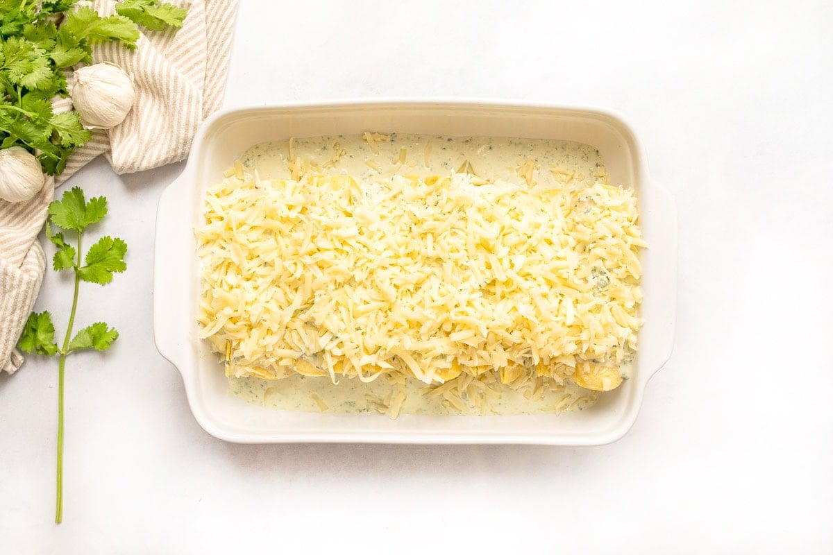 White Chicken Enchilada recipe with cheese on top ready for oven.