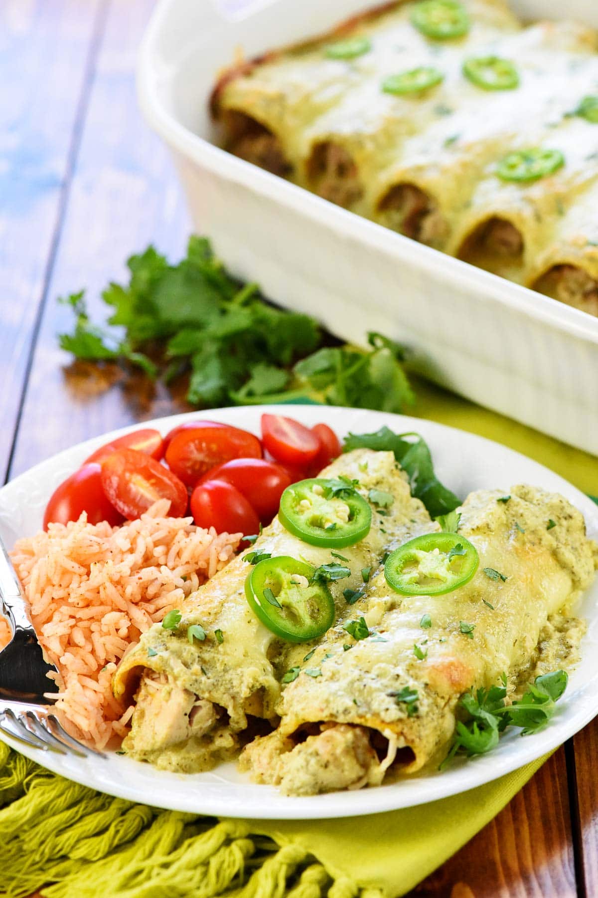 White Chicken Enchiladas in dish and on plate.