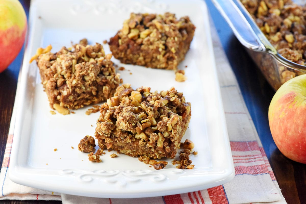 Apple Butter Bars on platter with apples on table.