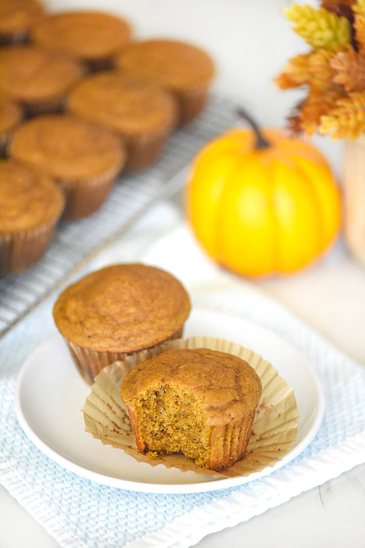 Healthy Pumpkin Muffins on plate and cooling rack.