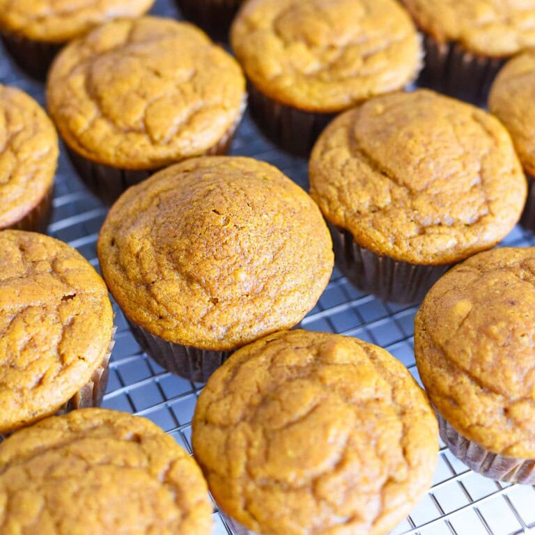 Healthy Pumpkin Muffins in rows on cooling rack.