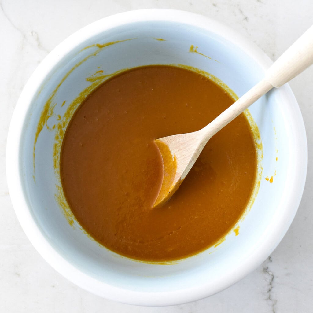 Wet ingredients for Healthy Pumpkin Muffins combined in bowl.