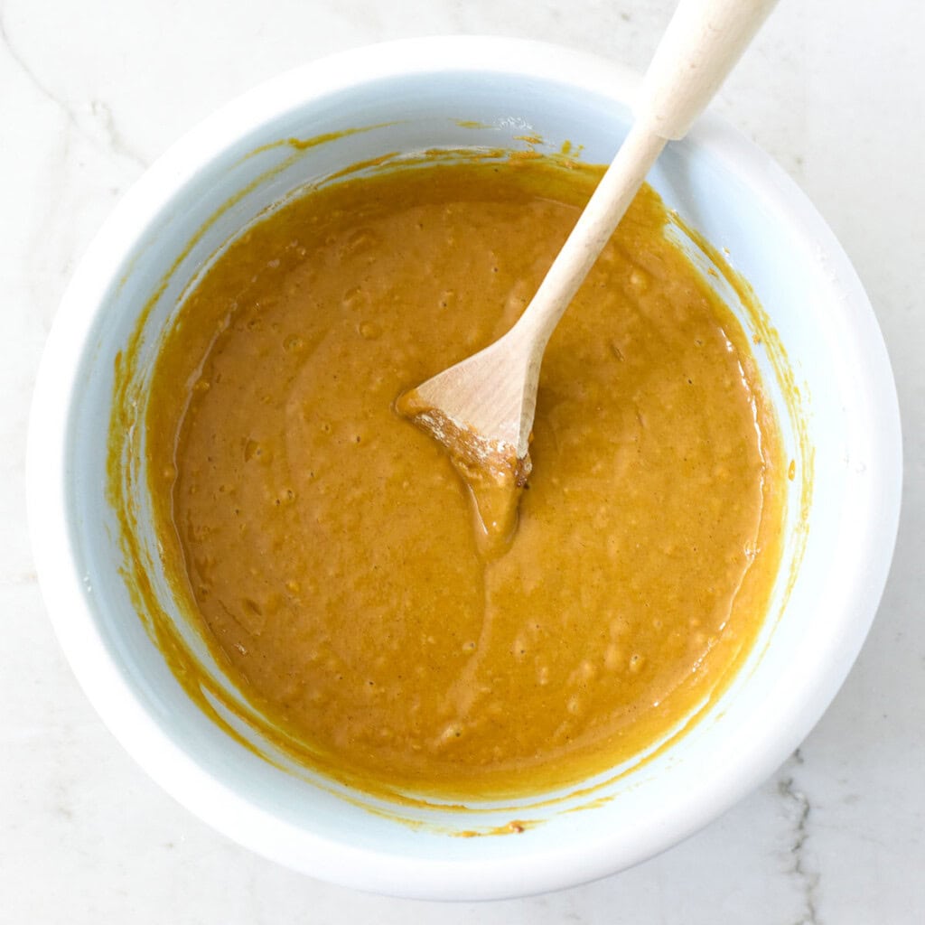 Flour mixed into batter for Healthy Pumpkin Muffins recipe.