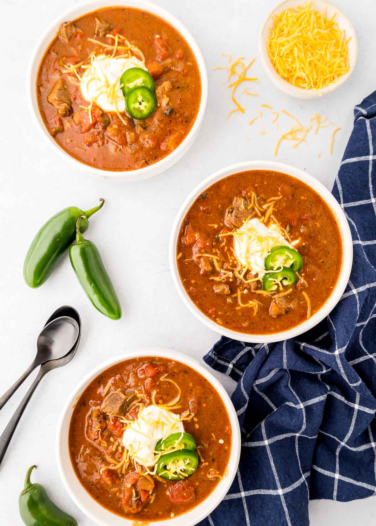 Aerial view of recipe for Texas chili in three bowls.