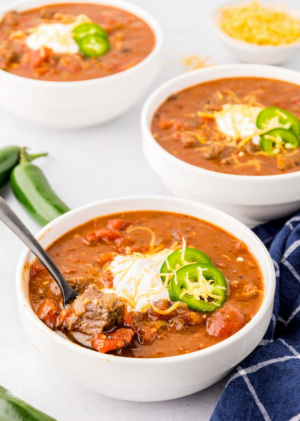 Texas Chili in three bowls with spoon.