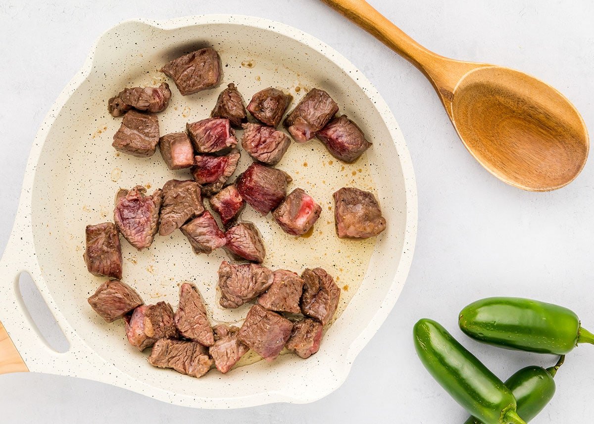 Chunks of beef browned in skillet for Texas Chili recipe.