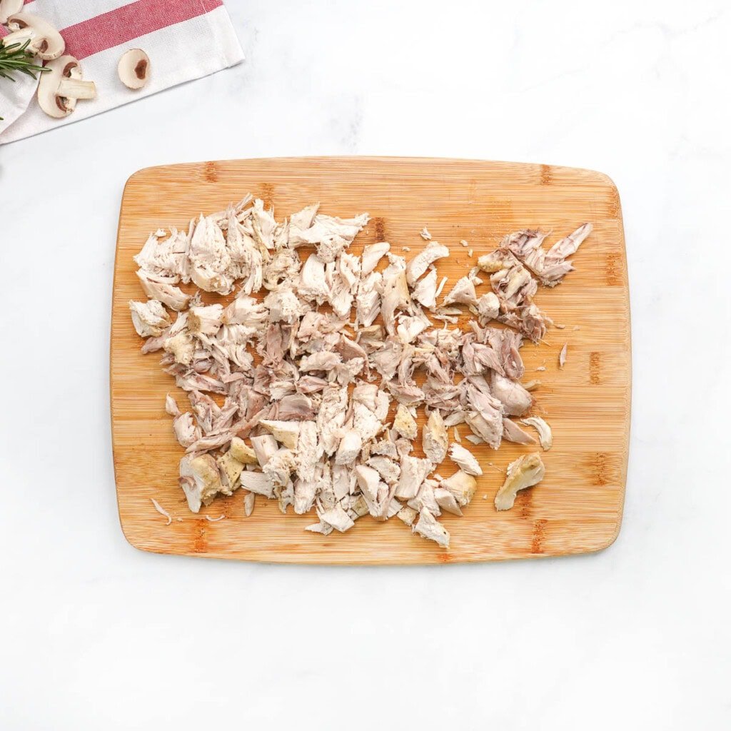 Shredded chicken ready to go back into Chicken Noodle Soup Crock Pot.