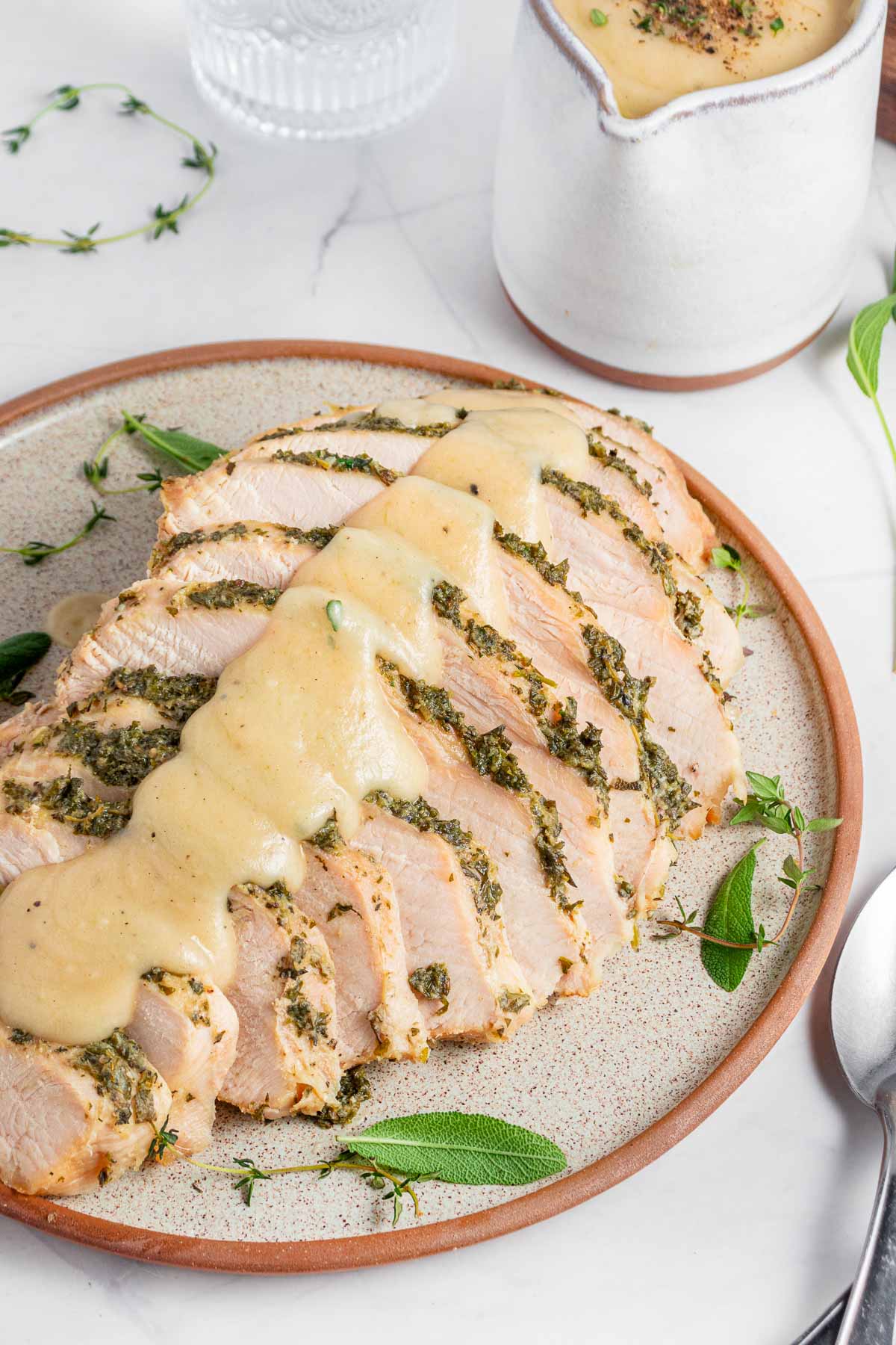 Crock Pot Turkey Breast with gravy drizzled on top and in gravy boat.