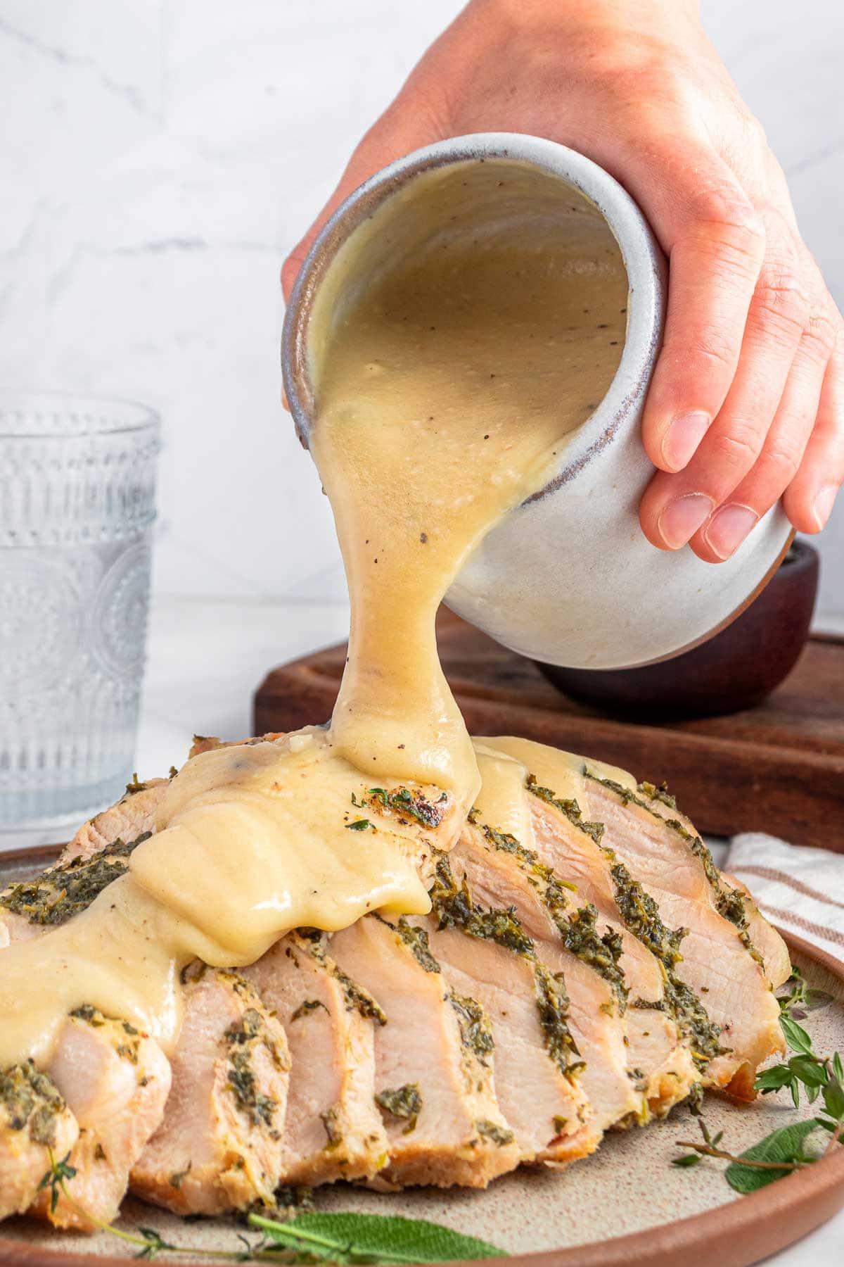 Pouring gravy over Crock Pot Turkey Breast.