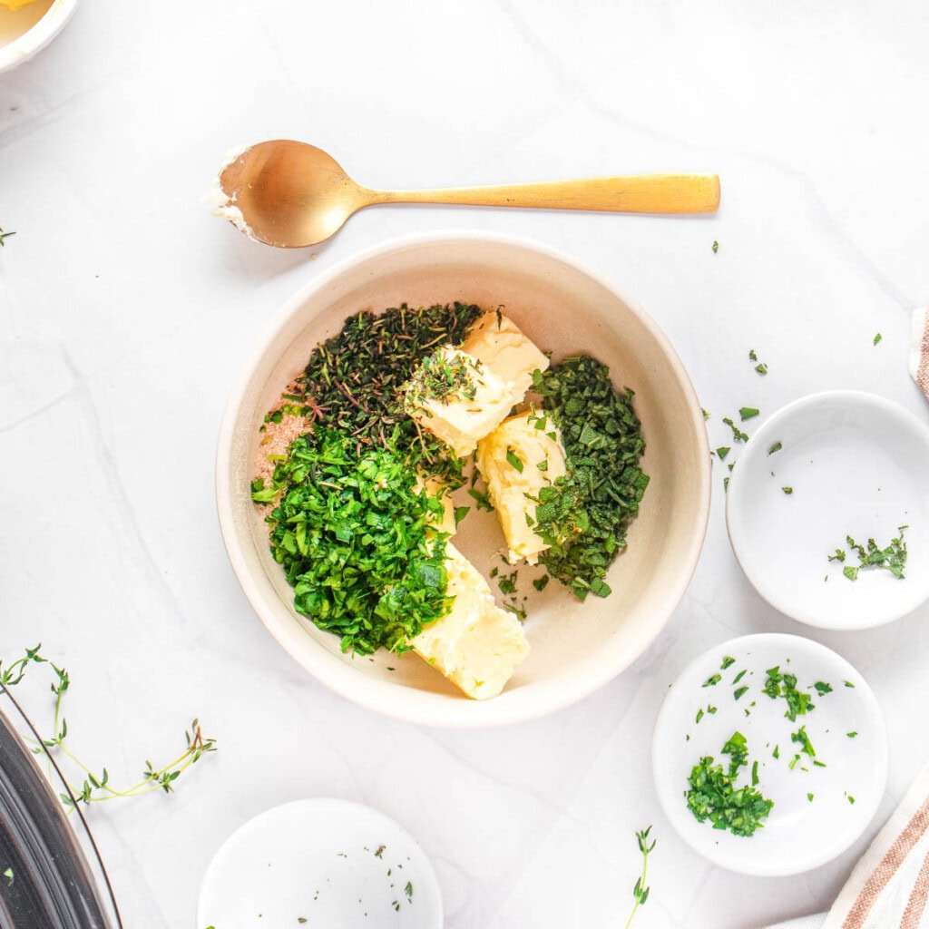 Butter and herbs in bowl.