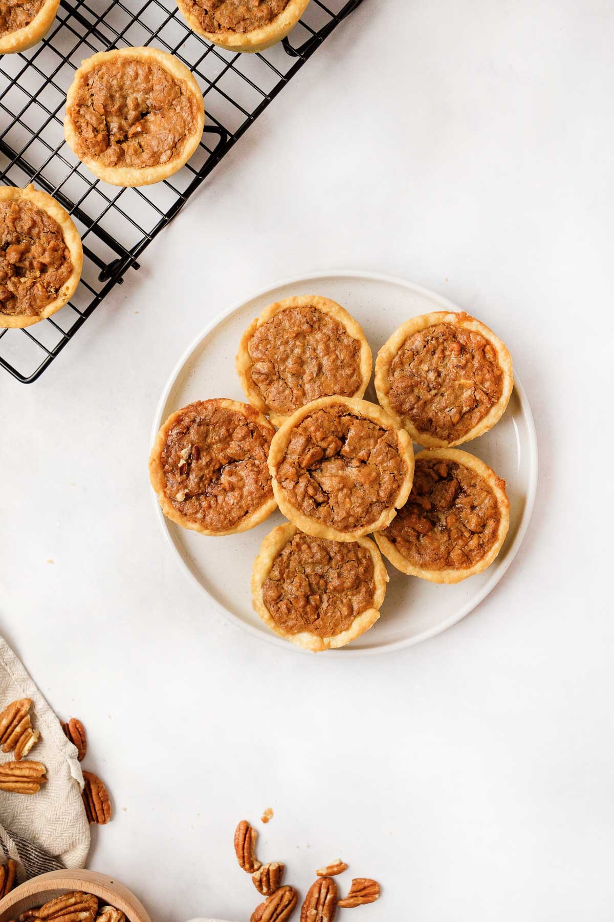 Mini pecan pie recipe on plate and cooling rack.