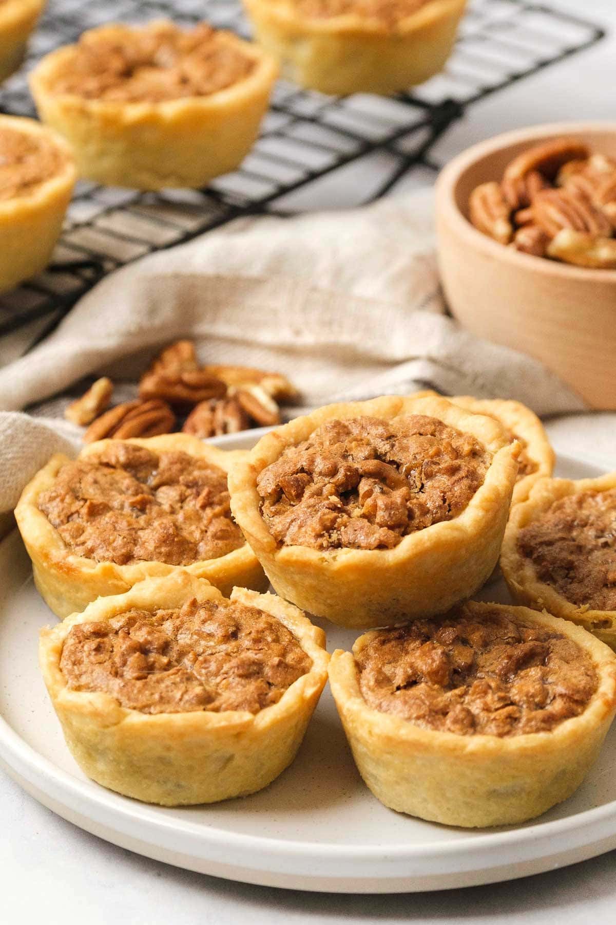 Mini Pecan Pies recipe on platter and rack.