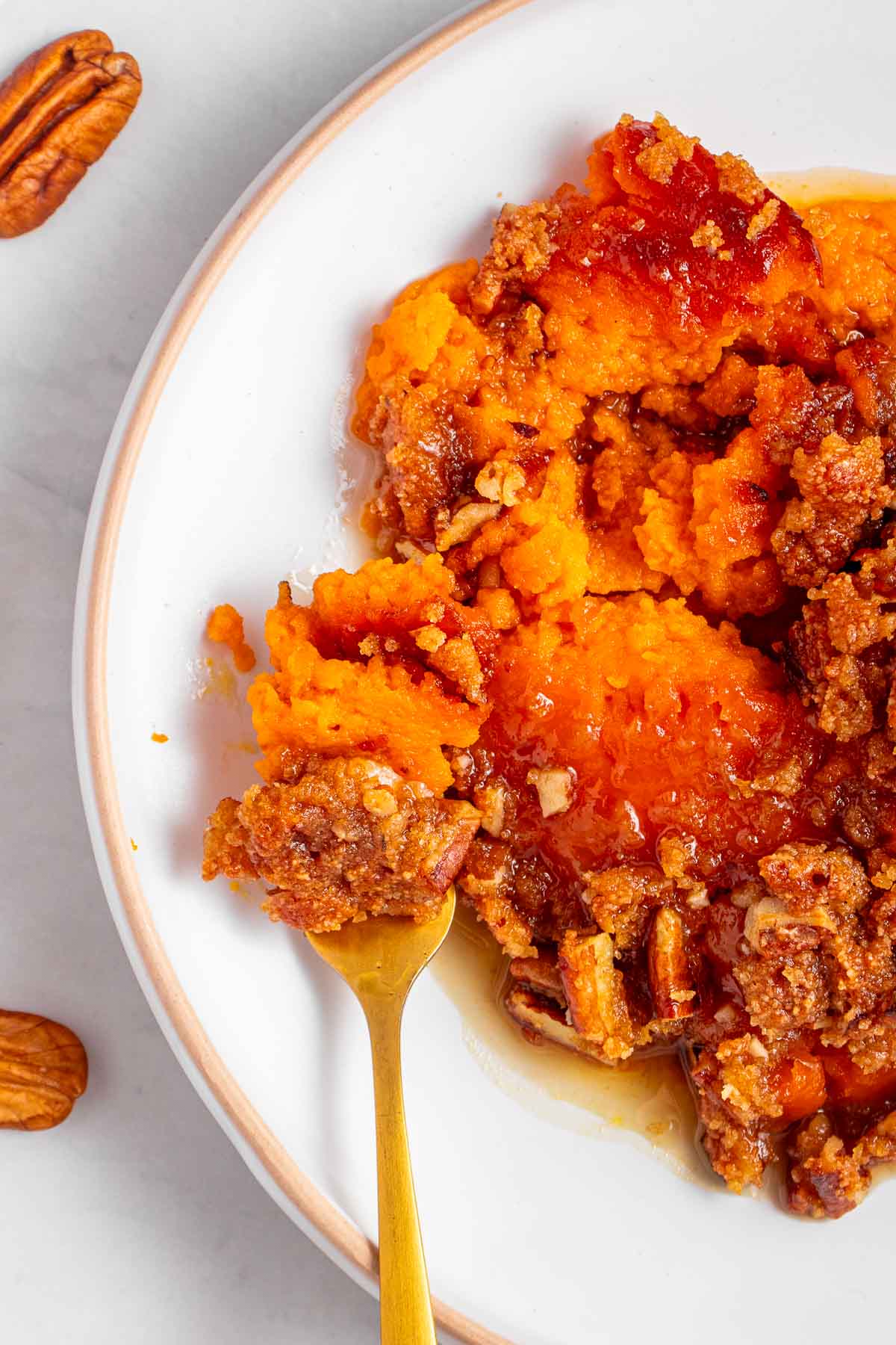 Old-Fashioned Sweet Potato Casserole on plate with fork for Thanksgiving side dish recipe.