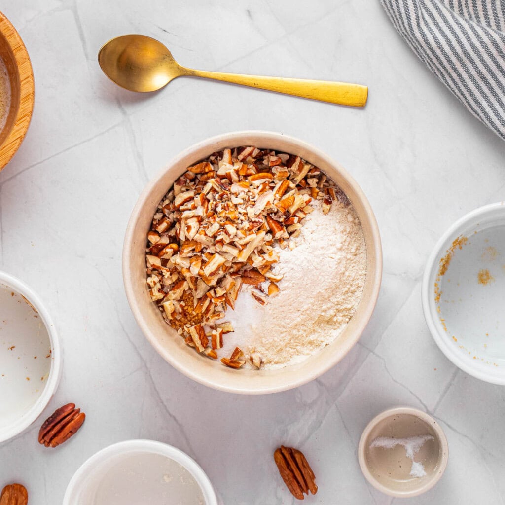 Combining flour, pecans, and sugar for topping.