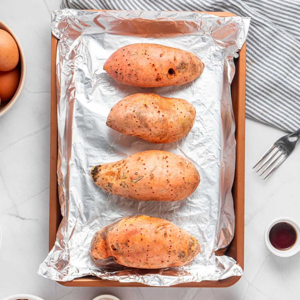 Sweet potatoes on baking sheet, ready for the oven.