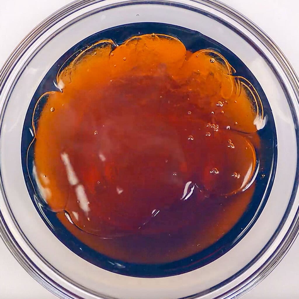 Maple syrup and water in glass bowl.