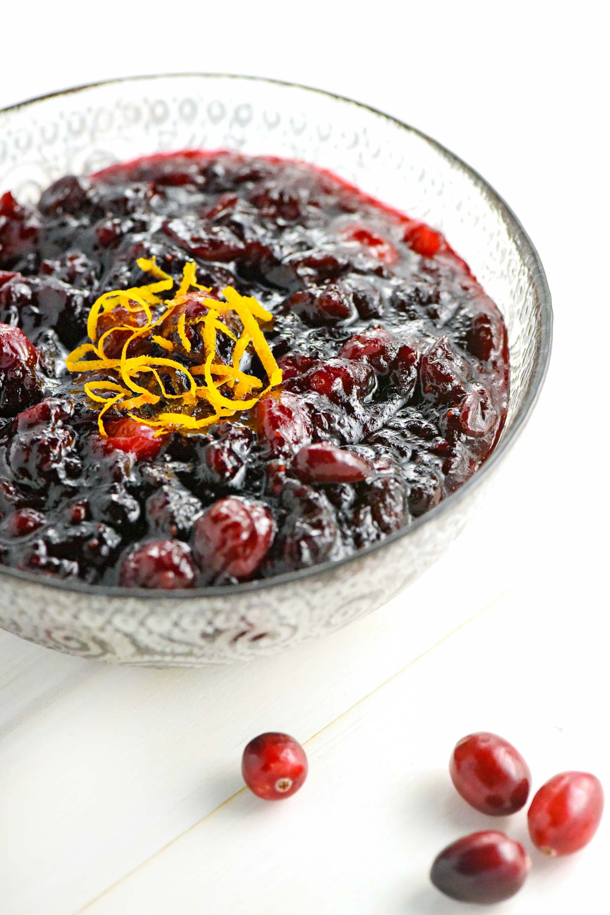 Cranberry Sauce with Orange with fresh cranberries on table.