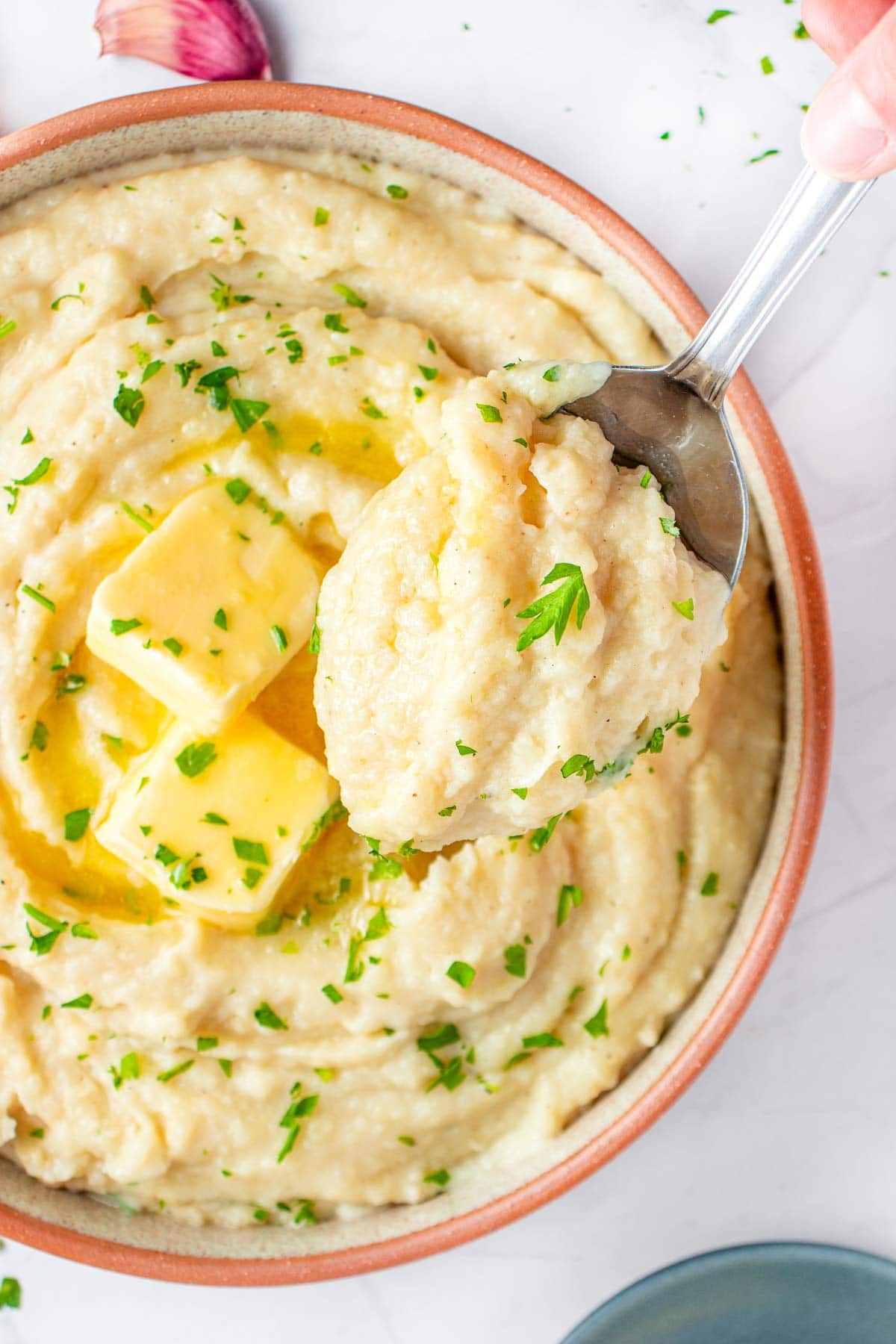 Crockpot Mashed Potatoes in bowl and serving spoon.