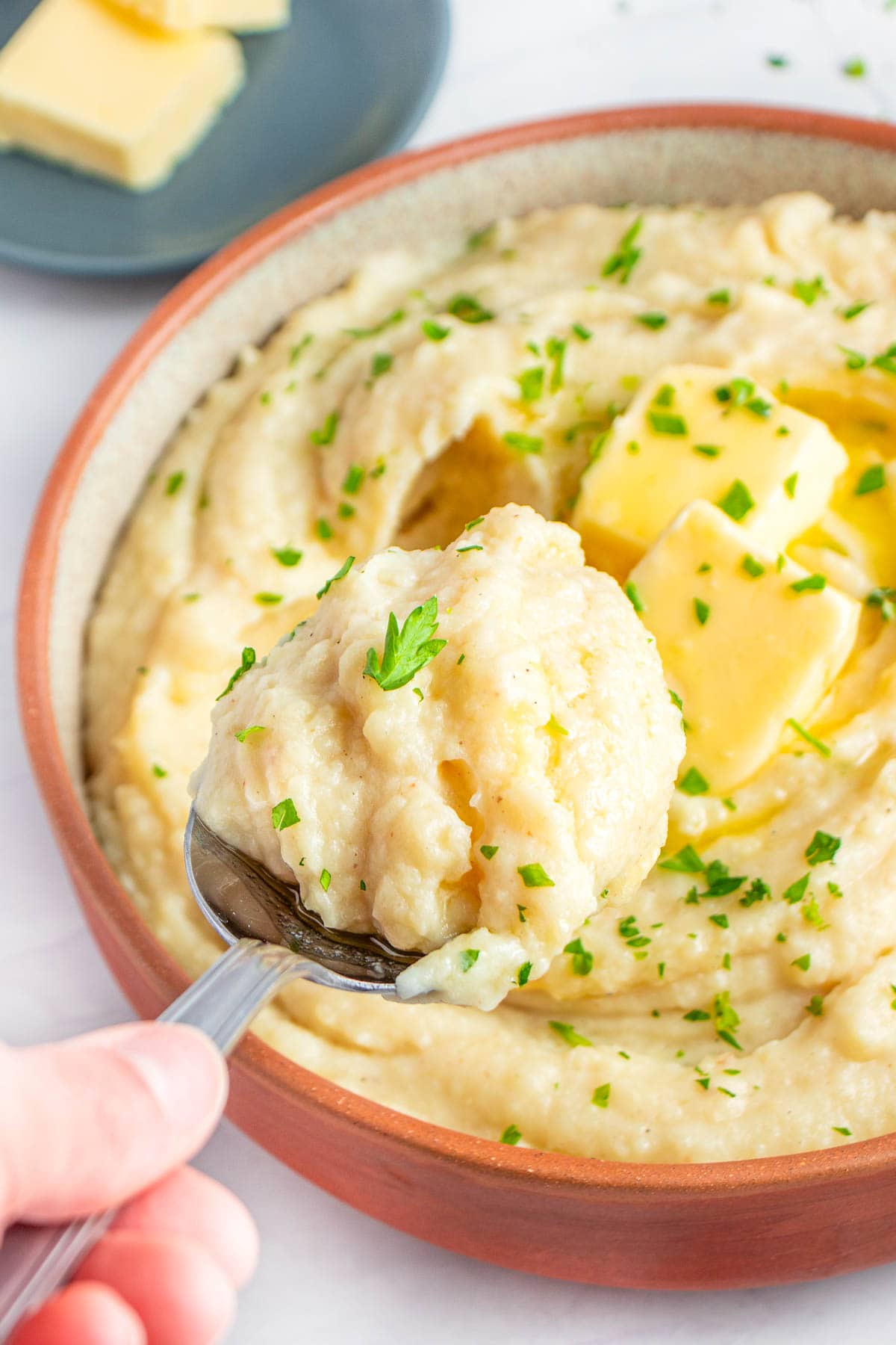 Crockpot Mashed Potatoes scooped into spoon.