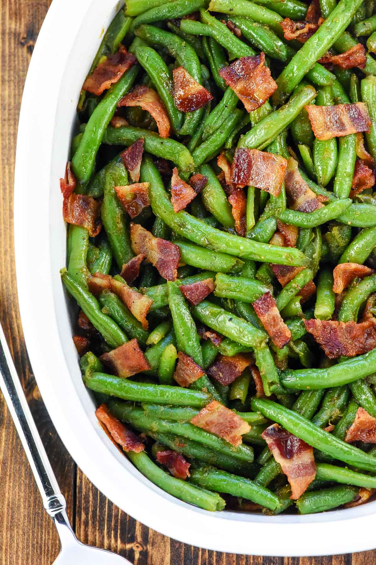 Green beans with bacon in a baking dish.