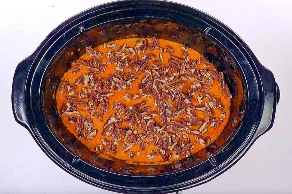 Crock Pot Sweet Potato Casserole in slow cooker with pecans.