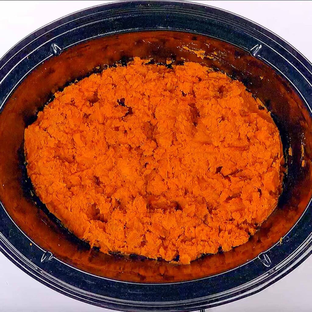 Mashed sweet potatoes in crockpot.