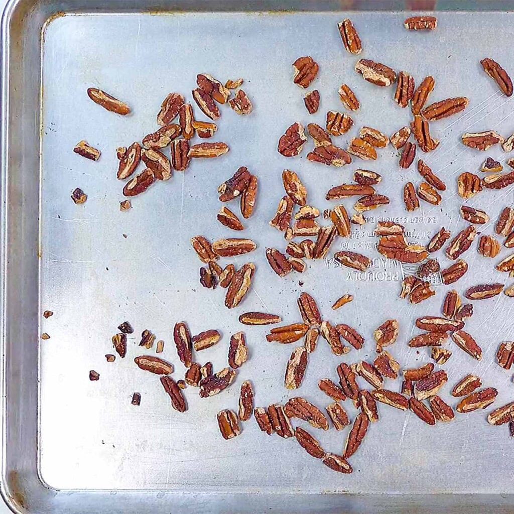 Pecans toasting on baking sheet.