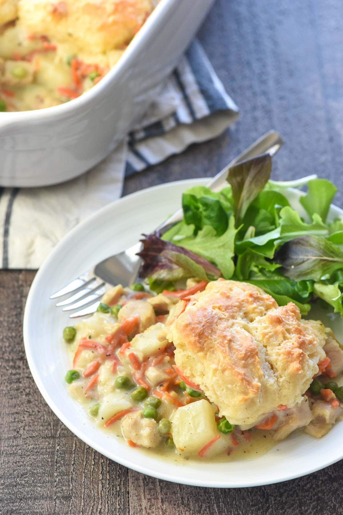 Chicken Pot Pie Casserole on plate with fork and in baking dish.