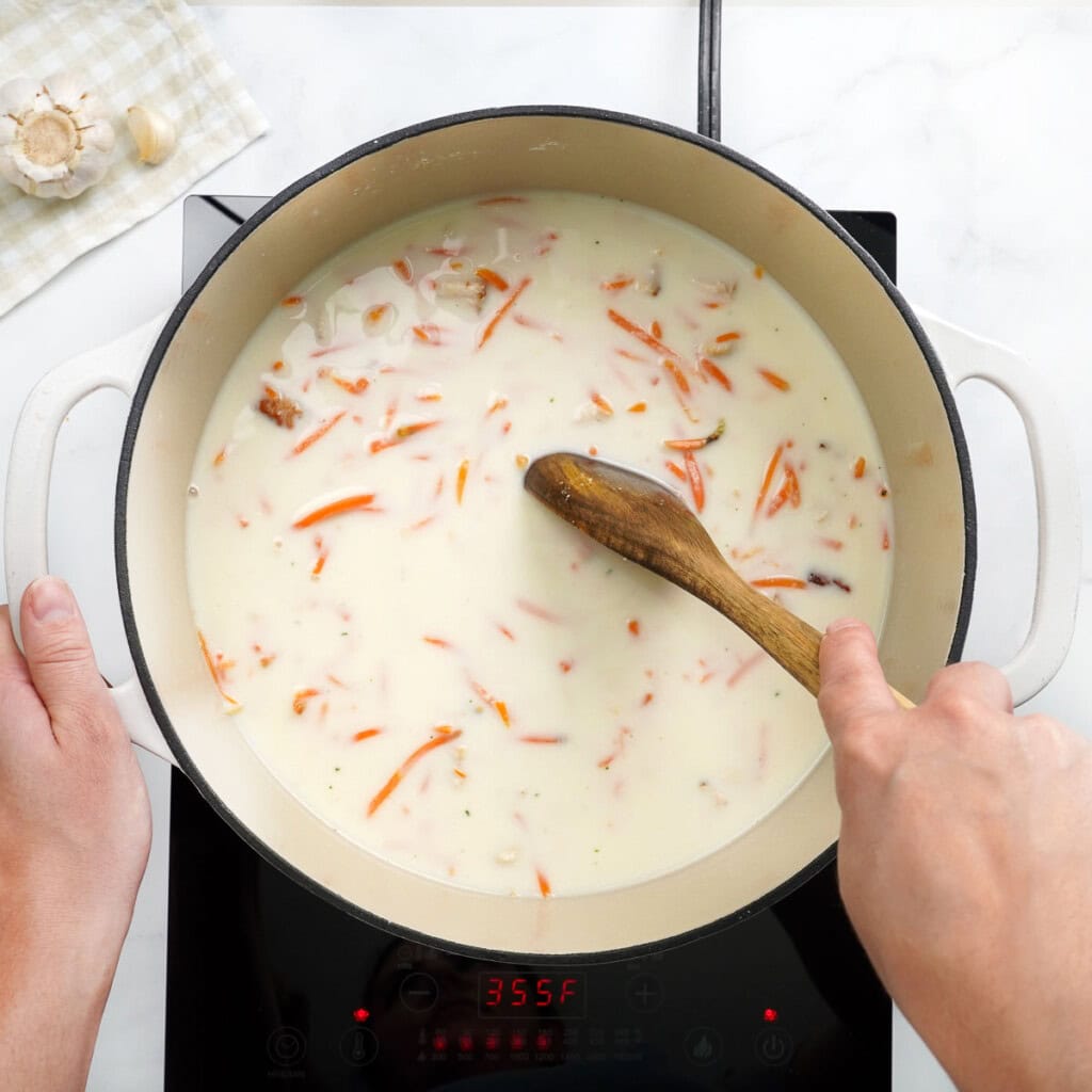 Stirring Chicken Pot Pie Casserole filling.