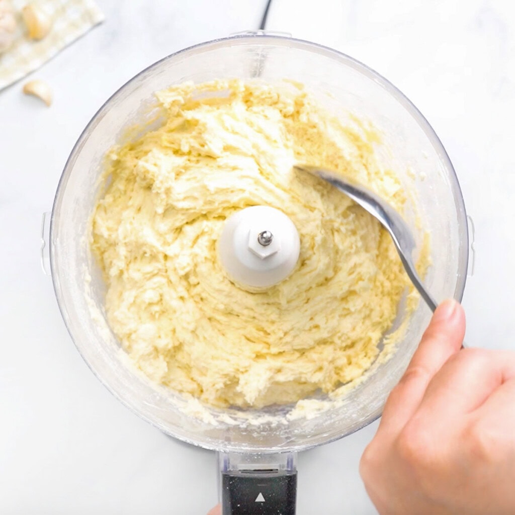 Scooping topping for Chicken Pot Pie Casserole with biscuits.