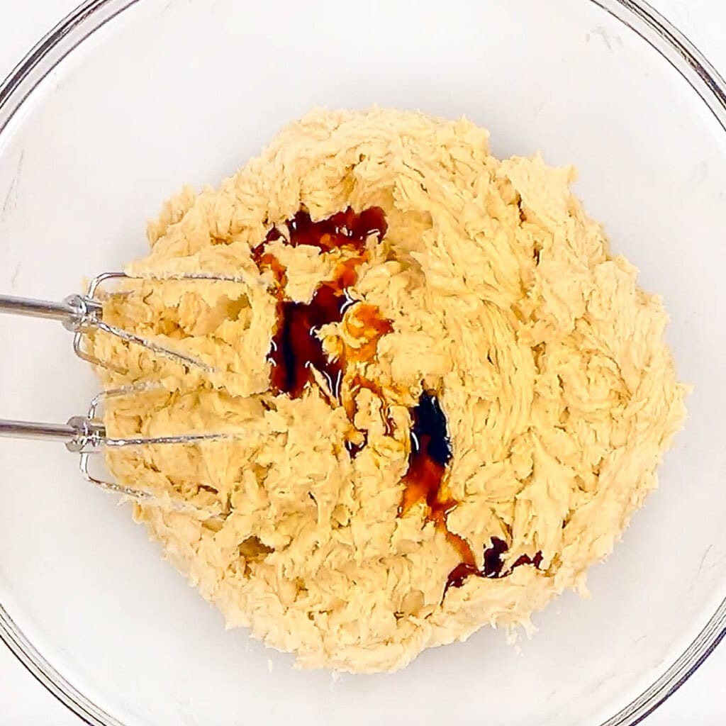 Adding vanilla to Cowboys Cookies dough.