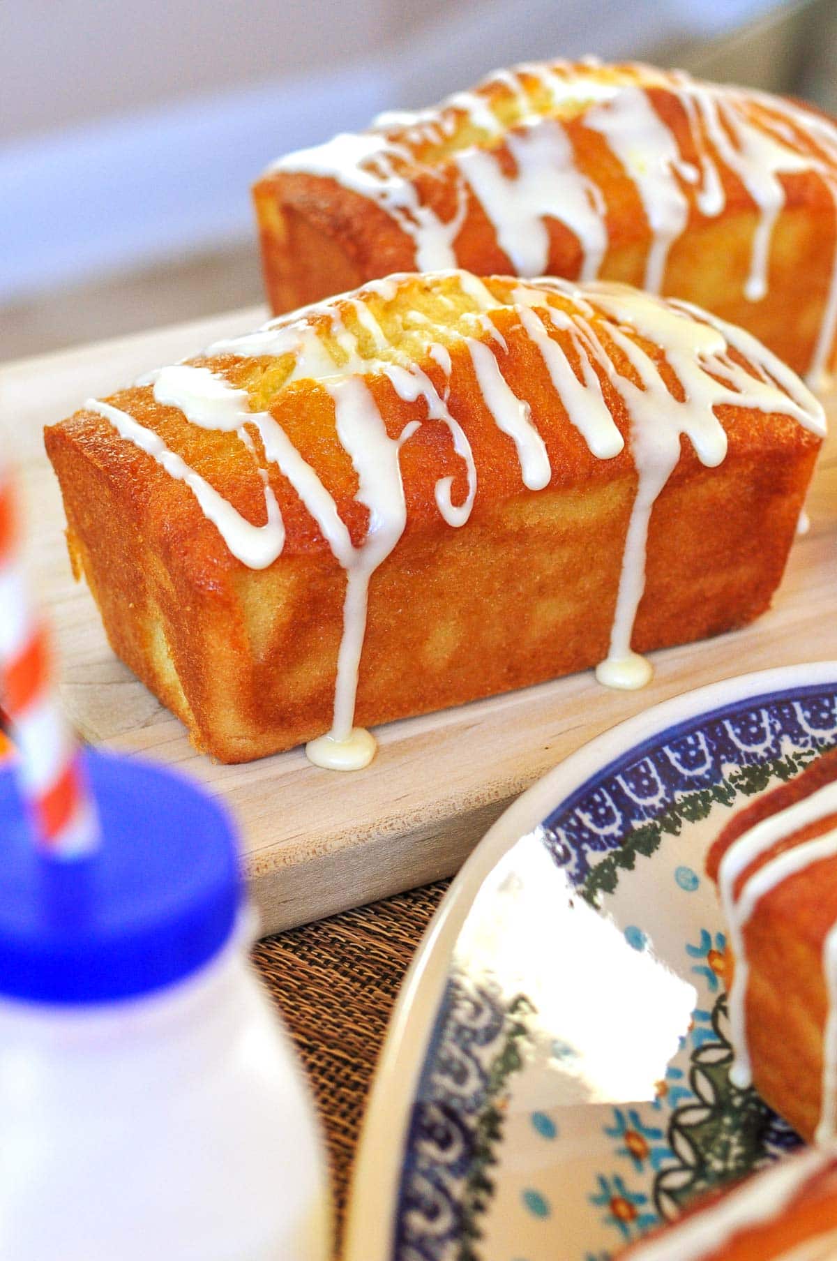 Orange Pound Cake mini loaves with citrus glaze dripping down the sides.