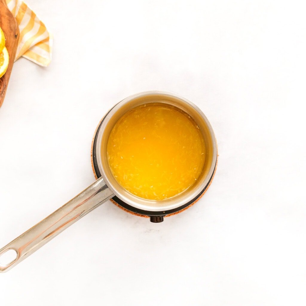 Fresh orange juice in saucepan.