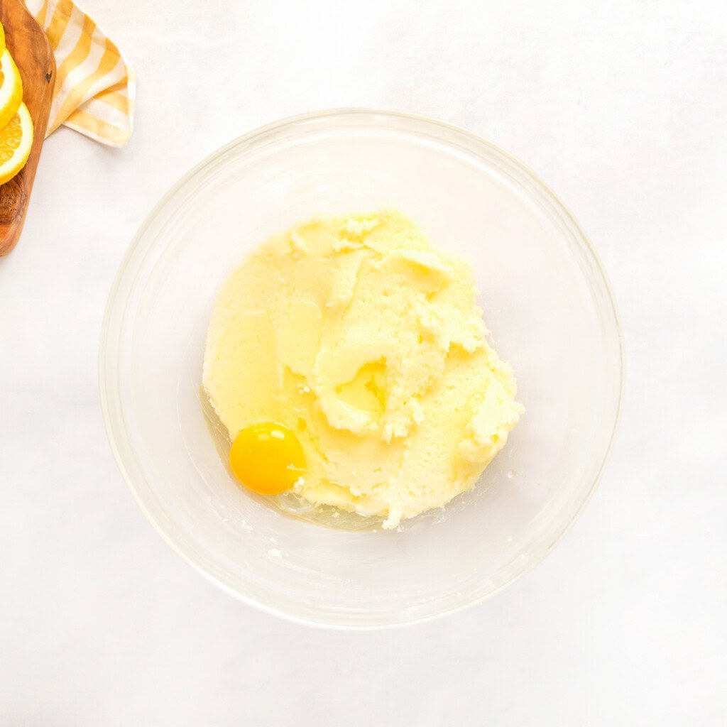 Adding eggs to Orange Pound Cake batter.